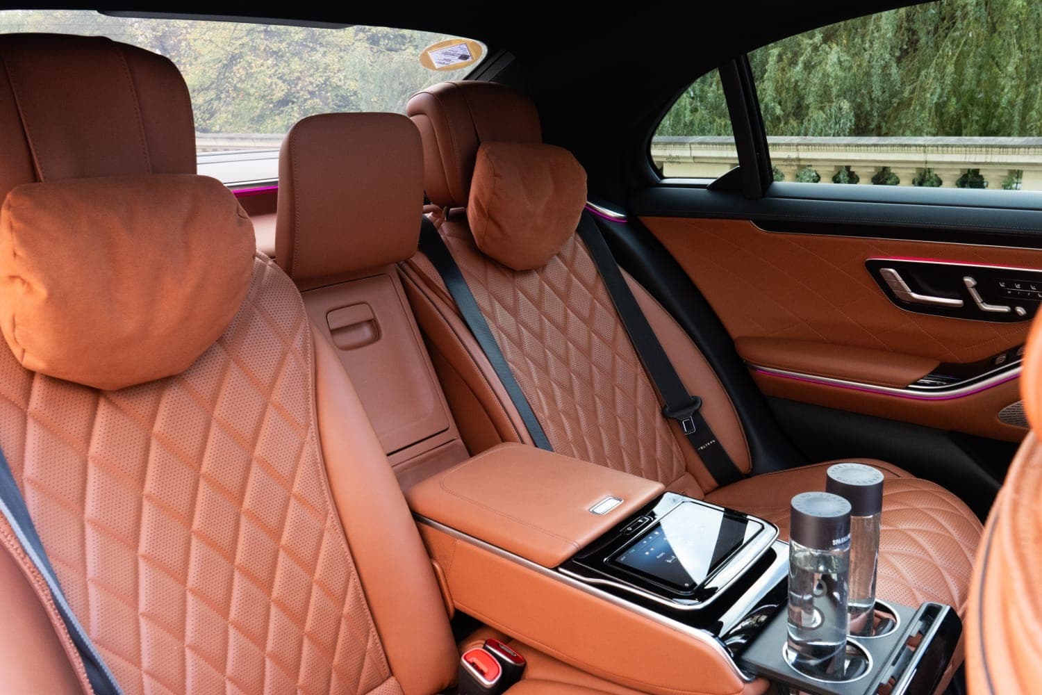 Rear cabin of a Mercedes S-Class with tan quilted leather and a centre console tablet