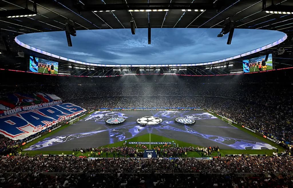 A packed stadium on Champions League final night, the UEFA Champions League starball displayed across the pitch