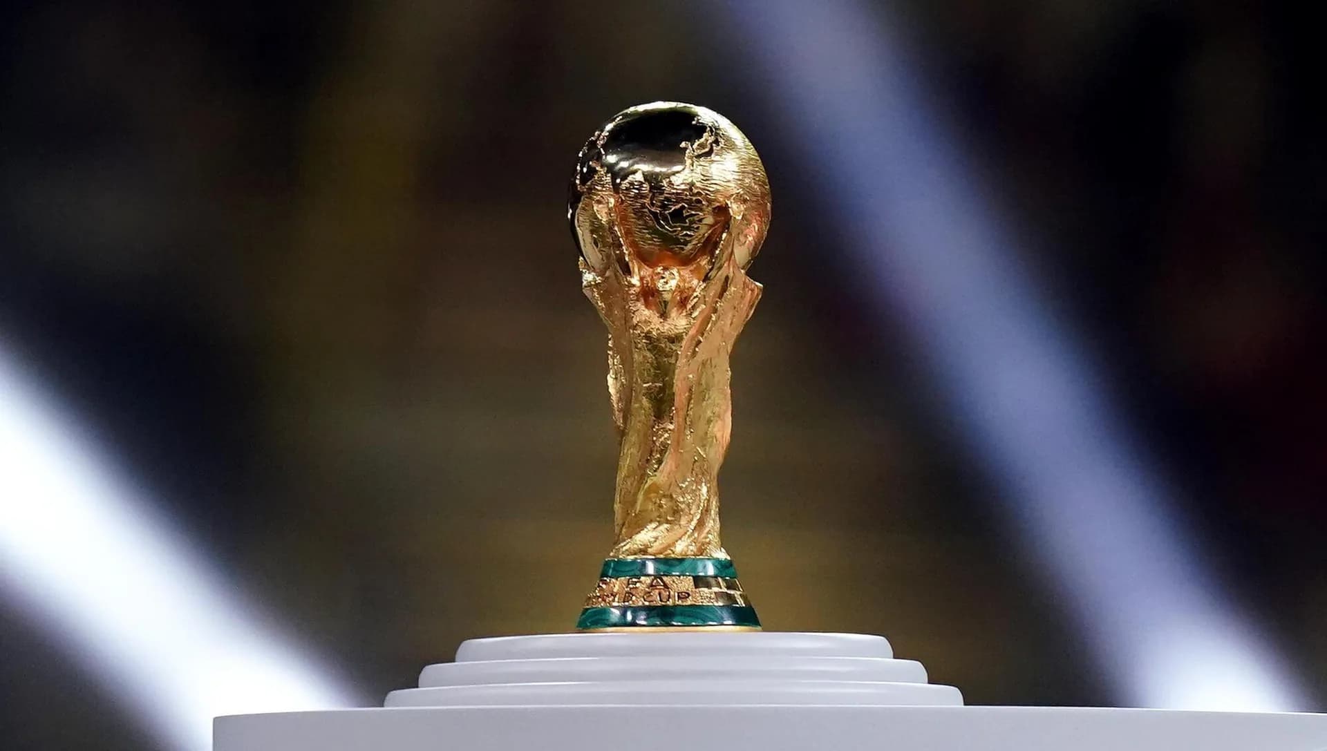 The FIFA World Cup trophy spotlit on stage - hospitality for the FIFA World Cup 2026